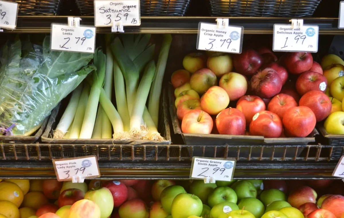 Fruit and vegetables on a stall with handwritten price labels