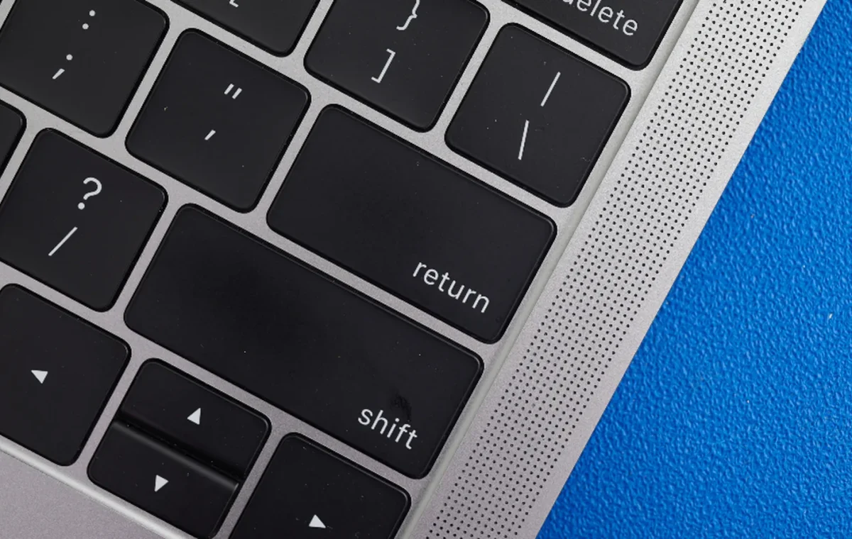 Close-up of the return and delete keys on a laptop keyboard