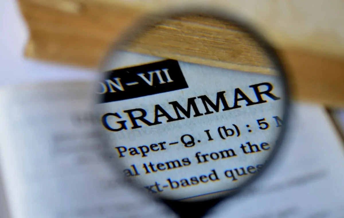 A magnifying glass over the word grammar on a printed page