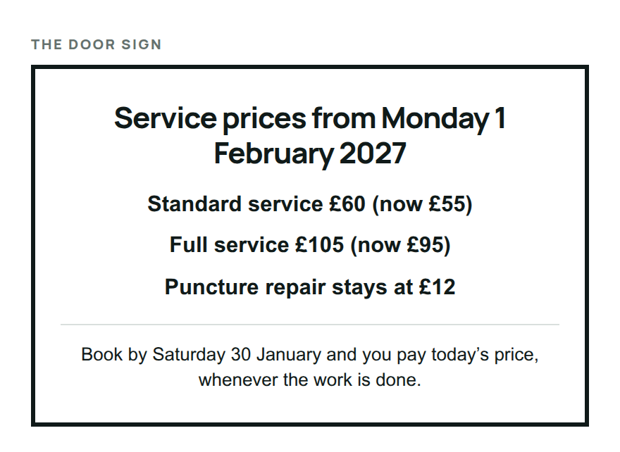 A door sign listing new service prices from Monday 1 February 2027, with the old prices in brackets