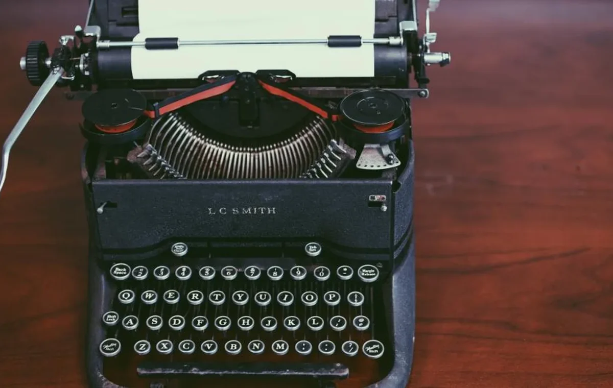 A manual typewriter with a sheet of paper in it